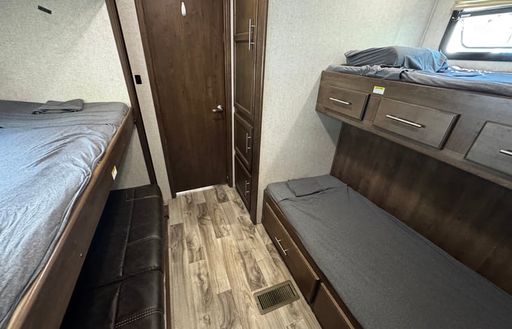 Bunk room with three twin beds and a couch that turns into a bed