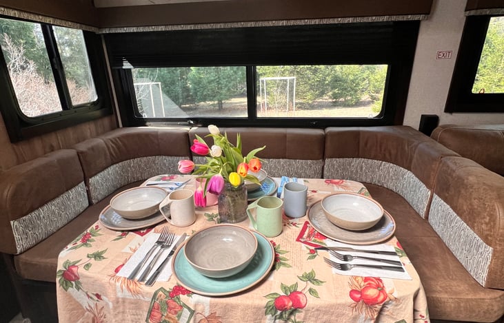 Dinette with seating for 4-6, folding chair provided for the front seat. Converts into a small full sized bed and sleeps 2 more. Provides additional seating for watching tv.