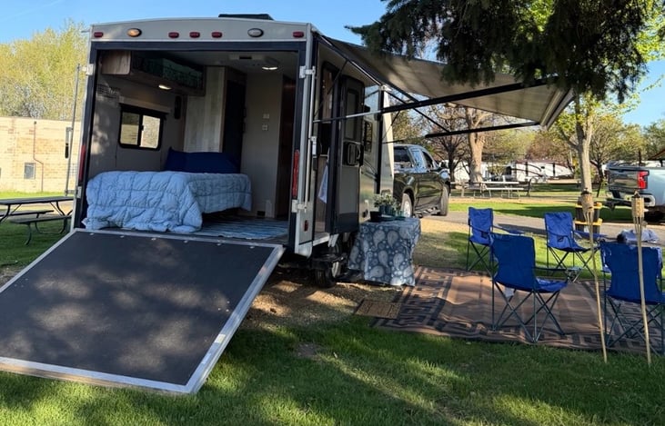 Cozy interior setup with rear ramp closed — opens during the day with screen enclosure for a fresh open-air feel.
