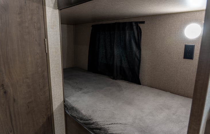 Lower Bunk: Opening Window (With Blackout Curtain), Wall Outlet and Light