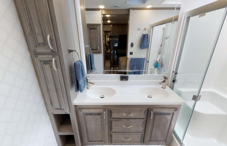 Unbelievable Master Bath with dual sinks, backlit mirror, oval toilet, and shower with 2/3 opening sliding doors and large bench.