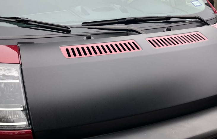 Blacked-out, vinyl-wrapped hood.