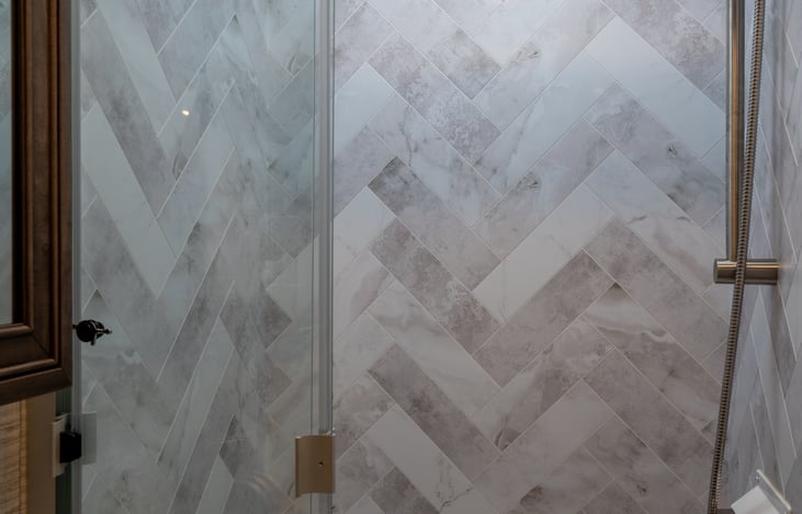 Bathroom with large shower, faucet and basin, and medicine cabinet.