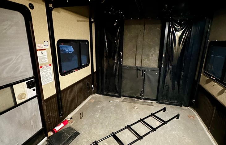 Large 11.5 ft garage with tie down anchors, vents, & extra storage.