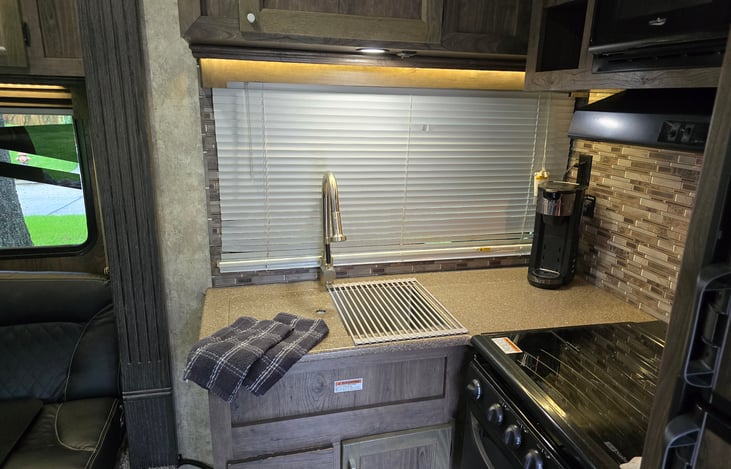 Deep basin kitchen sink with one out of two covers for added counter space.