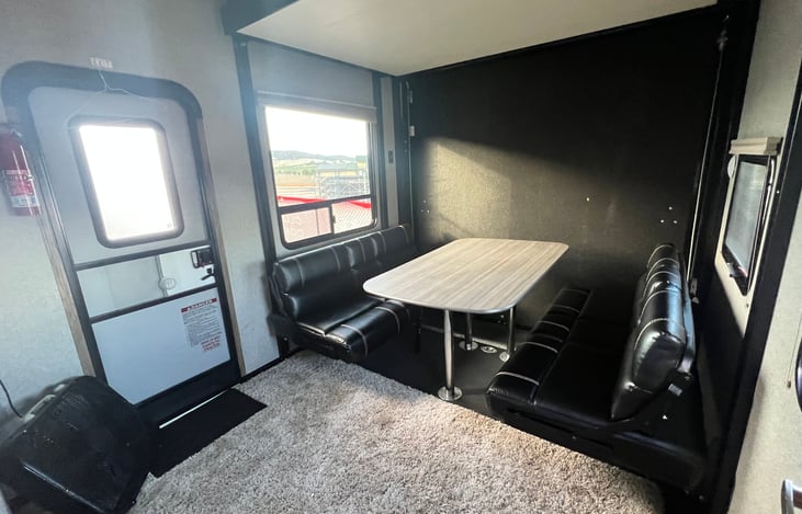 Garage with table & sofas set up.

Included fan & rug to keep it comfortable