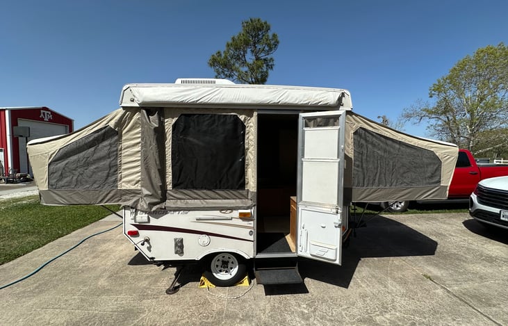 Front side of camper - popped up and door open.