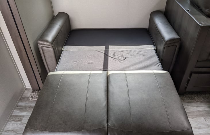 Trifold couch bed.  Better choice for taller adults than the dinette bed.