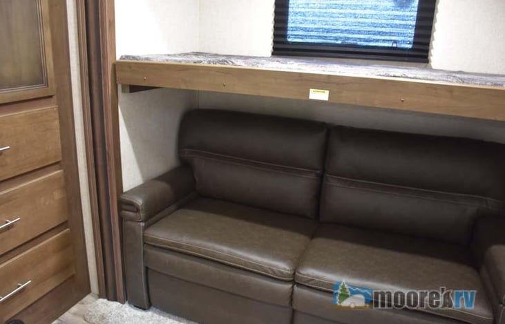 Slideout with bunk and couch that makes into a twin bed.