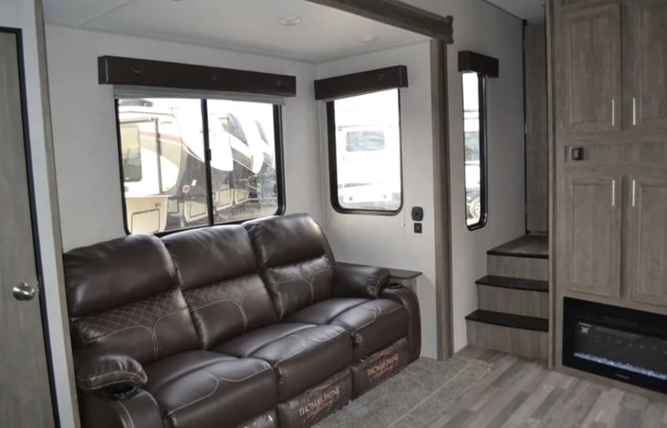 Reclining sofa - all 3 sections recline! Right & left recliners have heat and massage. Fireplace adds ambiance and heats the room nicely on a cold day. Slide-out makes this living area feel huge!