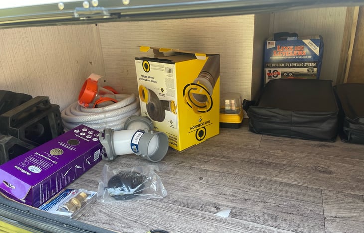 Water and sewer hookups. Sewer hose in bumper of camper