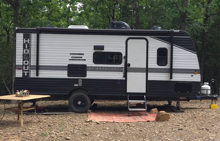 Solar powered awning,  camp mat, full propane tank, 2 solar batteries, leveling jacks front & back included