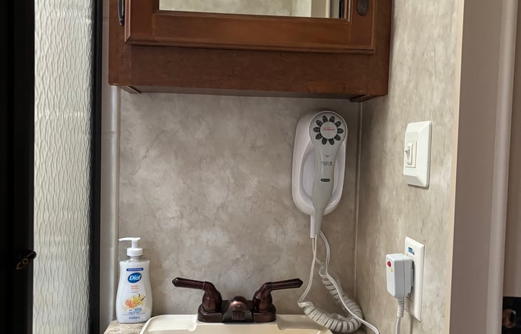 Bathroom sink w/medicine cabinet, under sink cabinet w/emergency cleaning supplies