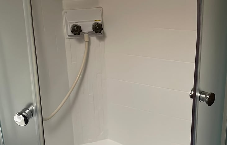 Large shower with sliding doors.