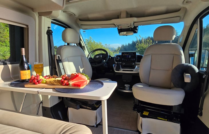 Swivelling front seats make easy utilization of dinning area and access to creative charcuterie.