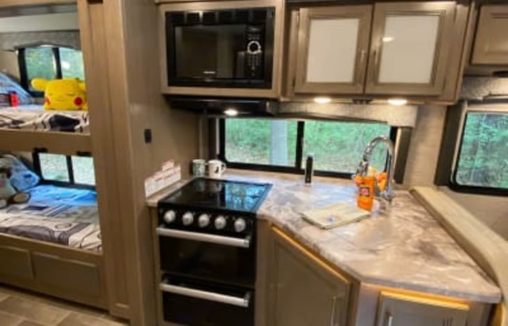 Microwave, stove with three burners and an oven.