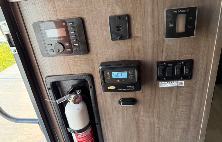 Interior: Solar Battery Charge Monitor, USB Ports, Radio/Bluetooth, Power Switches.