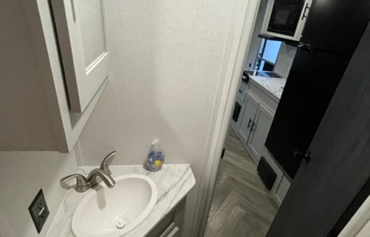 Bathroom sink also looking into the main living space. GFCI outlet to safely connect your hair dryer, straightener or charge your cell!