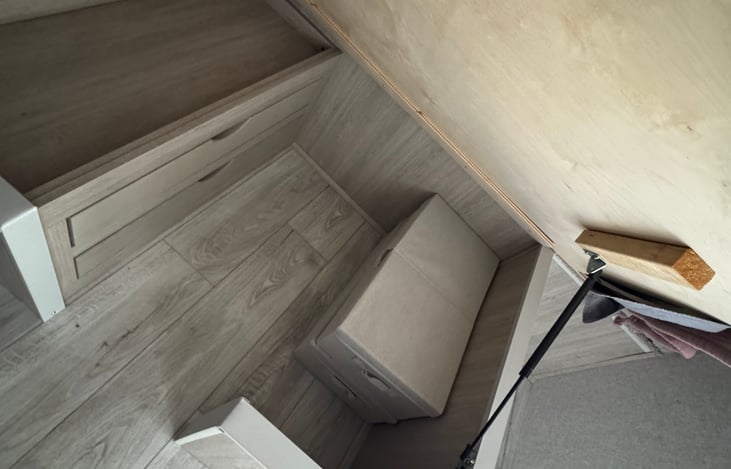 Under master bed storage. Bed lifts to access.