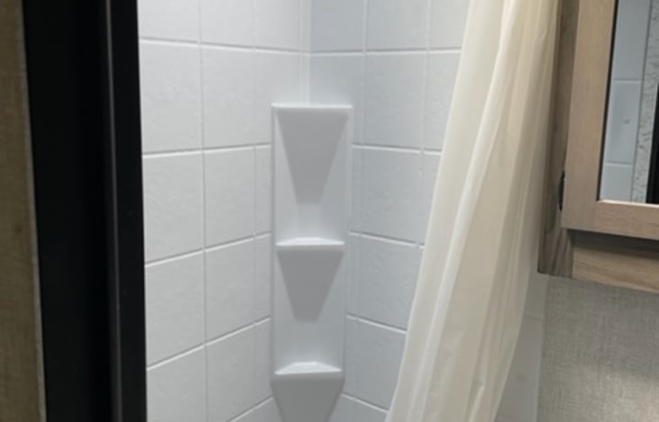 Shelving in the shower for your personal items.