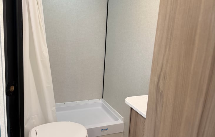 Clean, bright, and fully functional family bathroom stocked with fresh towels and essential toiletries.