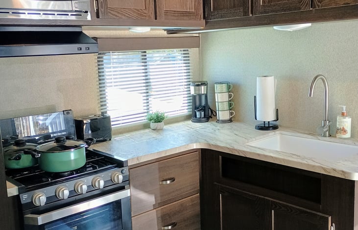 Kitchen comes supplied with Keurig single coffee machine, toaster, cups, plates, bowls, eating and cooking utensils.