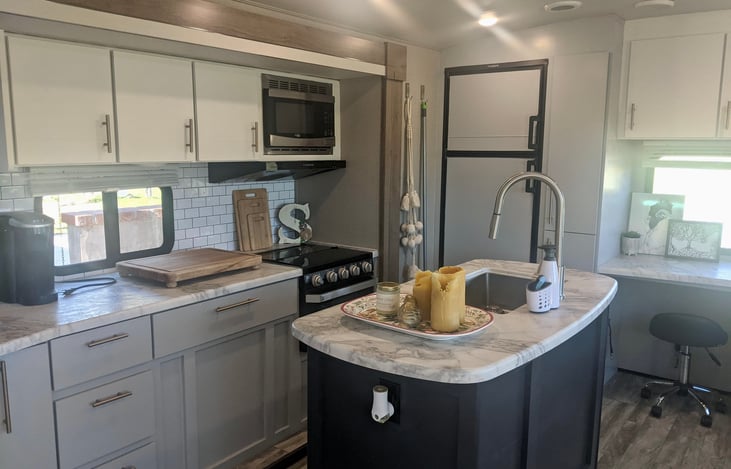 Large kitchen and island with plenty of cabinet storage.
