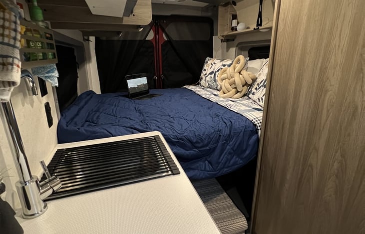 77" * 59" murphy bed with a ton of storage below when the bed is opened. Closing the murphy bed exposes additional cabinets below the head and foot of the bed.