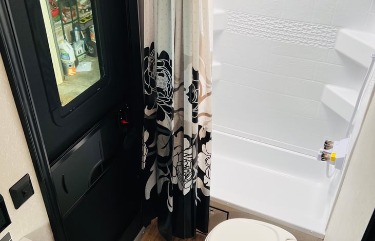 Bathroom with exterior door offering convenience.