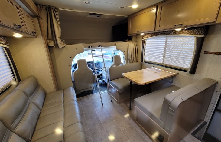 over cab long bed w/ TV, couch and dining bed conversions