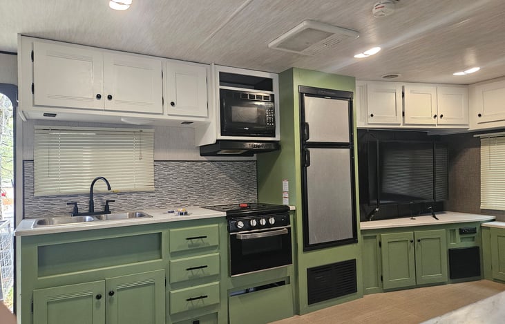 Beautifully painted cottage style kitchen to help you feel right at home, and added durability to the cabinetry.