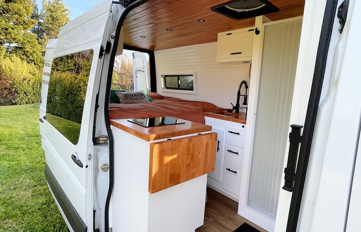 Open concept even with near king bed fully made. Induction stovetop with pot/pan included. Fully enclosed bath. MaxxAir Fan for ventilation.