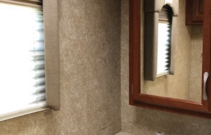 Bathroom with clean working toilet and vanity sink.