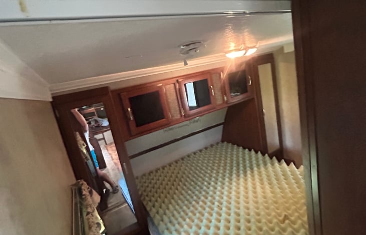 Wardrobe on both sides of the queen bed.