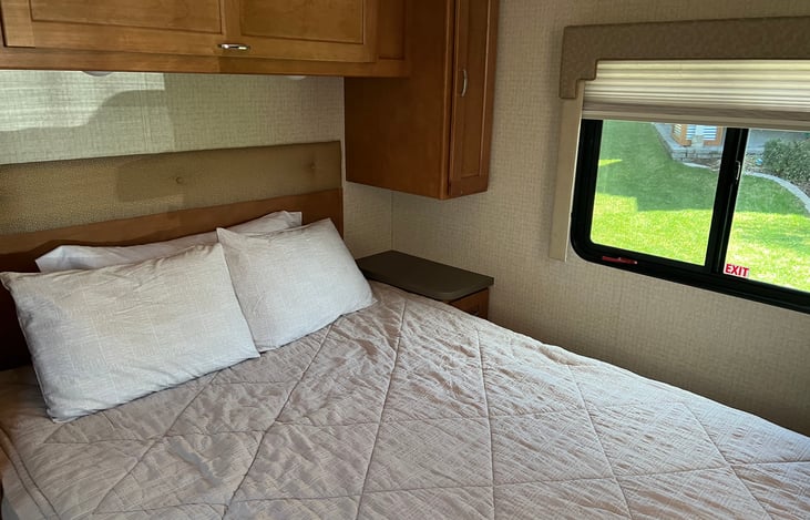 Rear queen bed for privacy and extra storage.