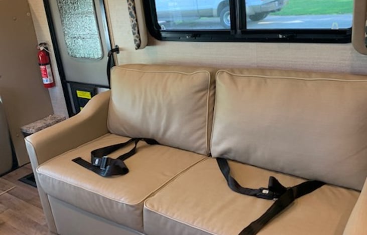 Couch across from dining table.  Can be used for eating, sleeping, and relaxing.