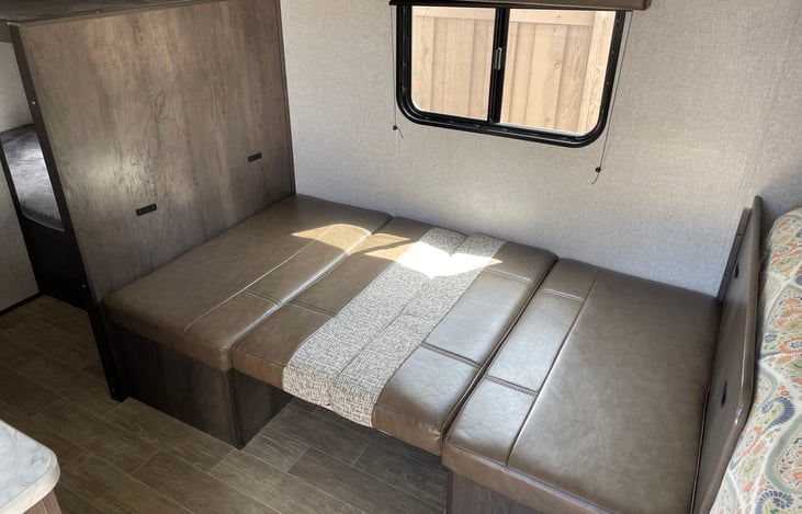 The kitchen table converts into a bed.