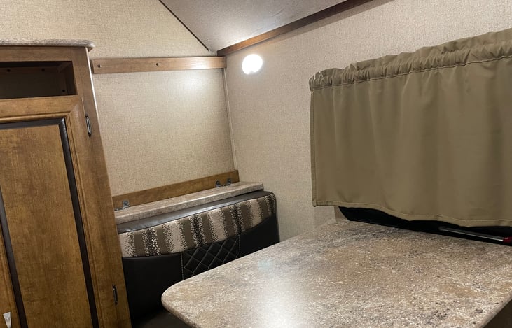 Bunkbed room activity table area.    Cabinet contains extra sheet sets, and blankets.