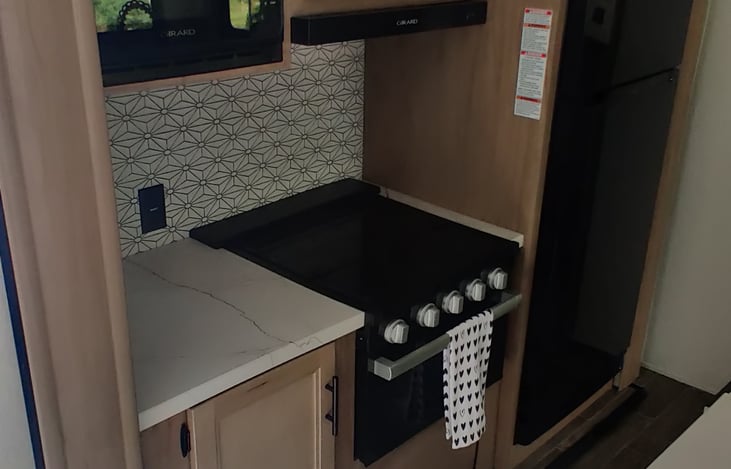 Refridgerator, freezer, microwave, 3-top gas burner