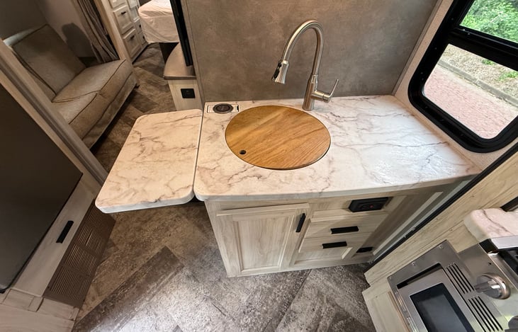Flip up counter on the side of the sink. Magnetic Phone charger in the corner