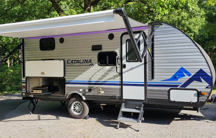 Exterior with awning and outdoor kitchen