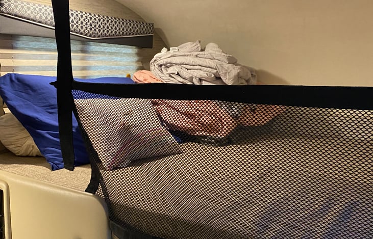 Full bed over cab with safety net employed