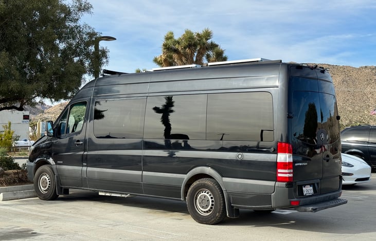 Left exterior. Can fit in spacious open parking lots at 23 ft long