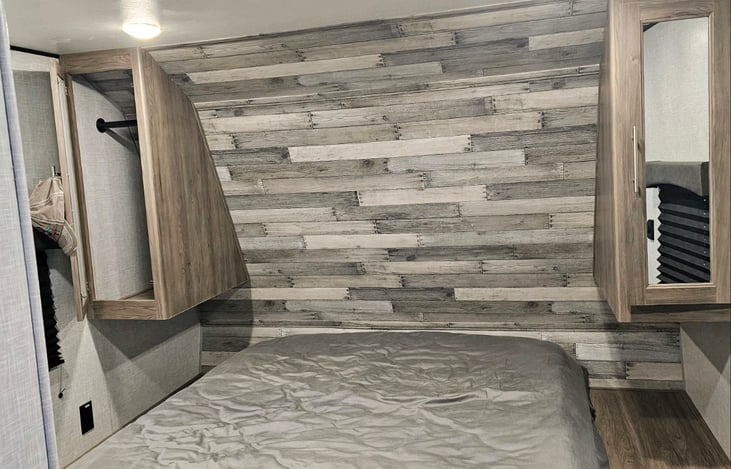 Next to bed closet area with mirrors.  Bedding can be provided if you need.