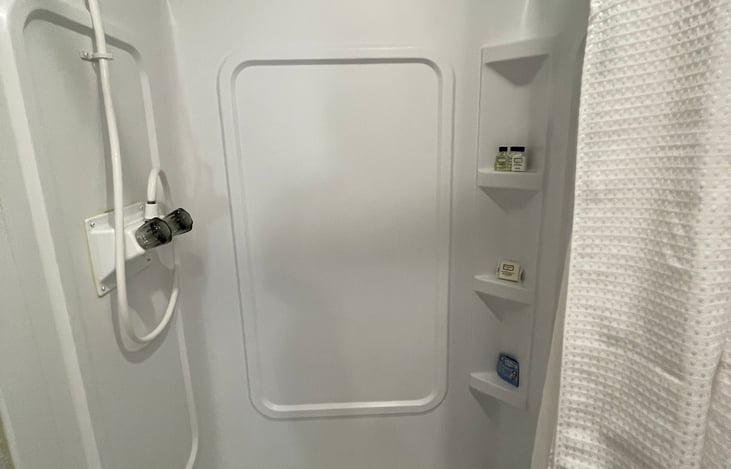 Shower is tall and allows for persons 6 ft+ to shower comfortably.