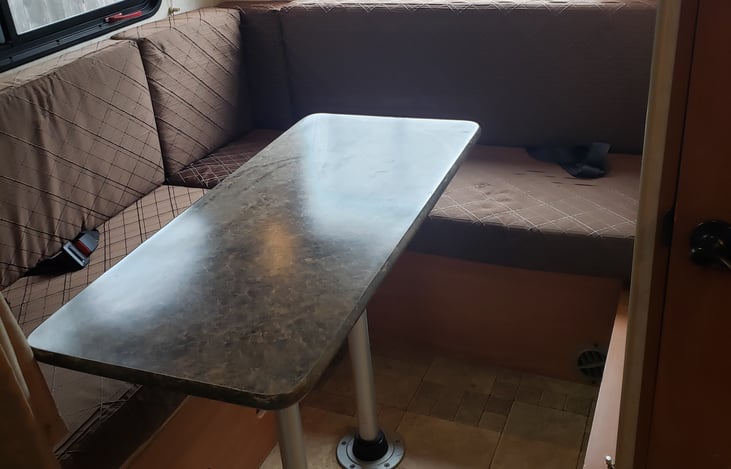 Rear dining that converts to double bed for two persons.