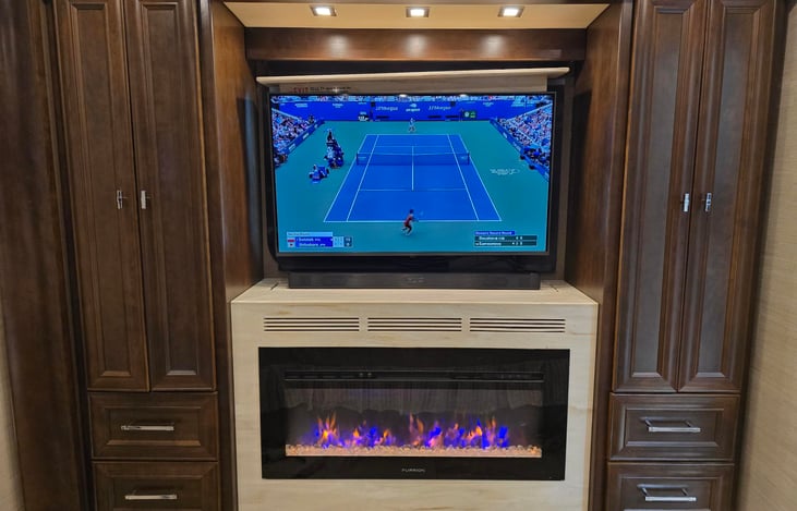 Bedroom has a Furrion fireplace that has high, low and no heat options.  The TV is on a televator so it can be lowered to show the window with a view or a shade for privacy