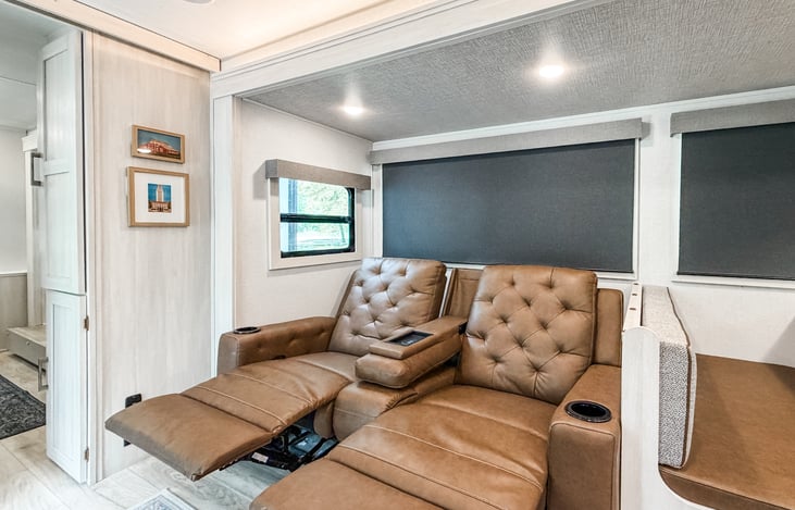 Theater seating in the living area with reclining seats.