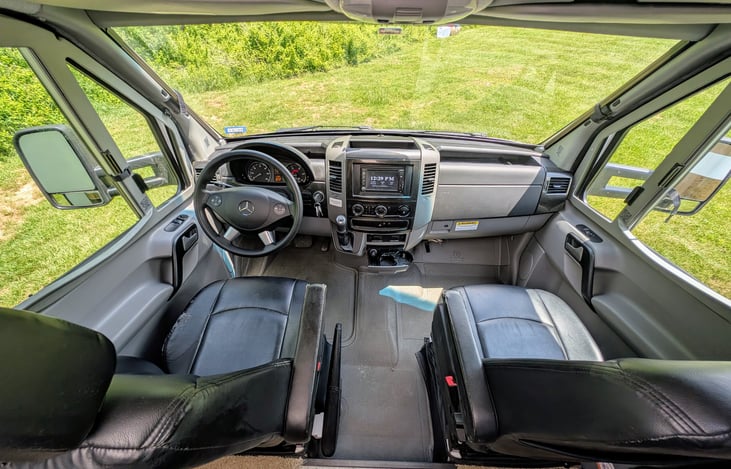 Comfortable Mercedes cabin with swing-around captain's chairs.