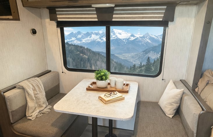 Side Dinette with large window and reading light above. Dinette converts into a bed for extra sleeping or lounge space!